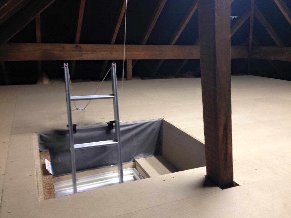 loft boarding attic with a metal ladder